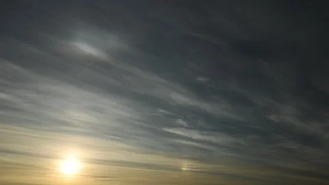 Wispy nighttime clouds drift across the sky in this time-lapse with the moon Stock Footage 256242691