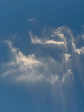 Wispy White Clouds Against Clear Blue Sky Stock Photos