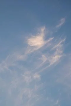 Wispy White Clouds in a Blue Sky Stock Photos