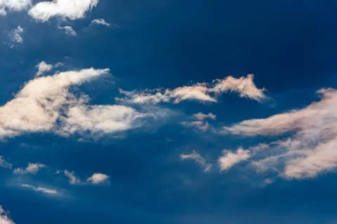 Wispy White Clouds in a Deep Blue Sky Stock Photos