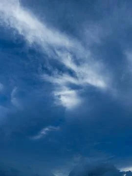 Wispy White Clouds in Deep Blue Sky Stock Photos