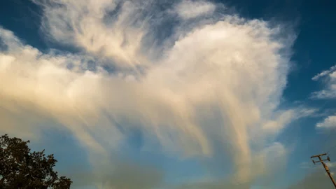 Wispy White to Yellow Clouds Float Across Blue Sky Timelapse Stock Footage 281336155