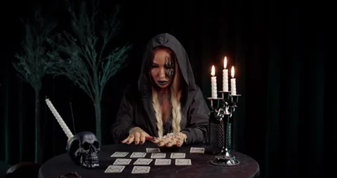Witch arranging tarot cards during occult ritual Stock Footage 319601418