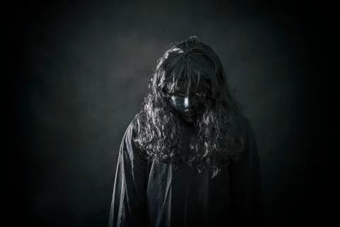 The witch in black cloak Stock Photos