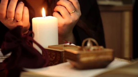 Witch blows out a white candle. Occult, esoteric, divination and wicca concept. Stock Footage 108013350