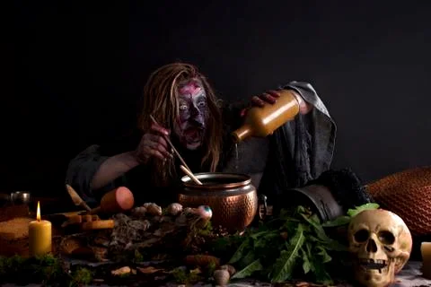Witch brewing potion in laboratory Stock Photos