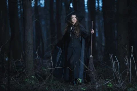 Witch with a broom in the forest Stock Photos