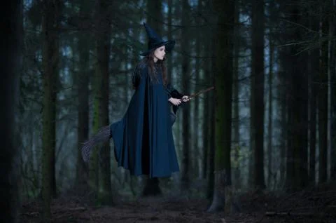 Witch with a broom in the forest Stock Photos