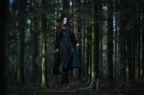 Witch with a broom in the forest Stock Photos
