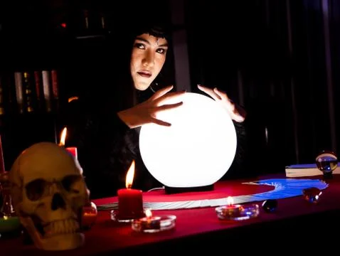 The witch is casting a spell to perform a ritual. 스톡 사진