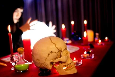 The witch is casting a spell to perform a ritual. 스톡 사진