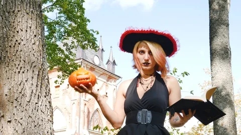 Witch casts spell book pumpkin  halloween magician paranormal Stock Footage 116120458