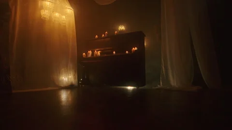 A witch casts spells with black candles in a dark background, evoking voodoo and Stock Footage 244434198