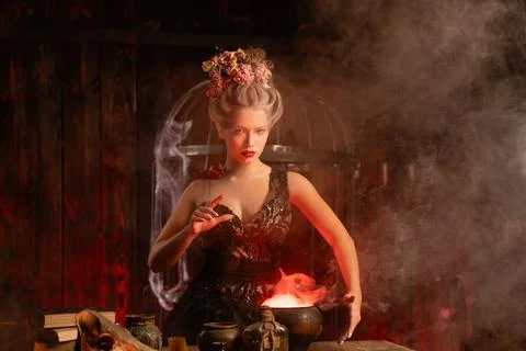 Witch with cauldron conjuring magic spell Foto stock