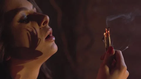 The witch conjures in a dark room, saying a plot by candlelight, close-up 4k Video stock 242426462