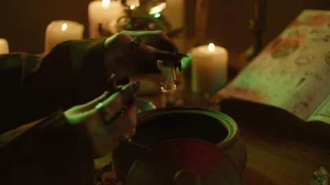 Witch cooking potion elixir close-up. Table with spellbook for making rite Video stock 161334764
