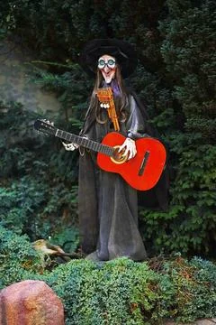 A witch doll in black clothes and a pointed hat Stock Photos