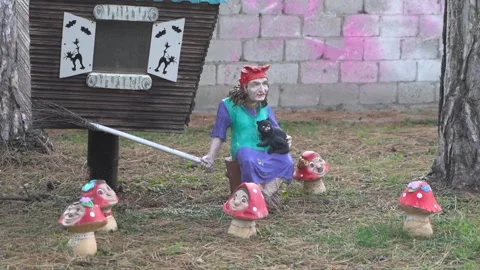 A witch doll for Halloween in a hat with a broom among mushrooms. Video stock 229502653