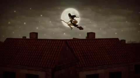 Witch flying on broomstick with pumpkin in the Halloween evening Stock Footage