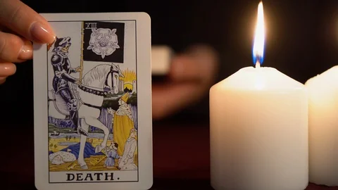A witch is fortune teller in black mantle shows tarot card of 13 Arcana: Death. Stock Footage 117805774