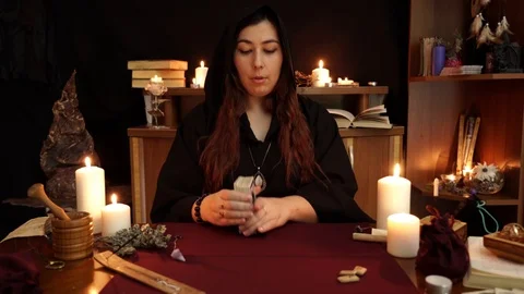 A witch is fortune teller lays out the cards on the table. Mystic background. Stock Footage 108010796