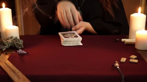 Witch is fortune teller mixes a tarot deck. Esoteric, divination, wicca concept. Stock Footage 108011673