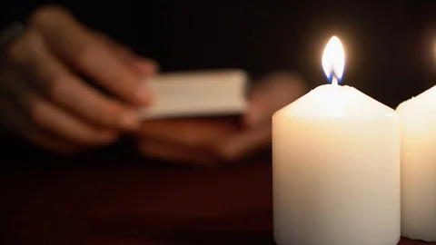 A witch is fortune teller shows tarot card: Ace of Cups. White candles on table. Stock Footage 117805336