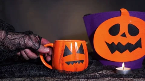 Witch hand grabs her brew at Halloween 스톡 동영상 161899661