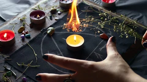 Witch hands burning herbs for a magic ritual with the help of magical altar Stock Footage 242773859