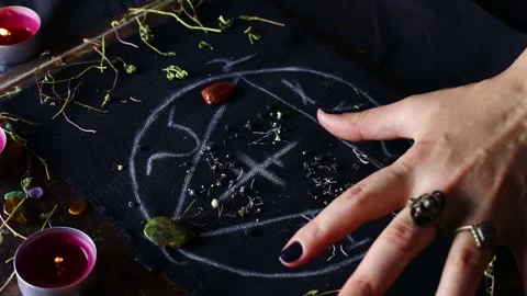 Witch hands performing a black magic ritual with the help of magical altar Stock Footage 242773931