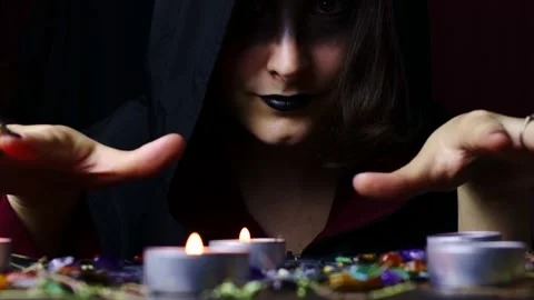 Witch hands performing a black magic ritual with the help of magical altar Stock Footage 242774081