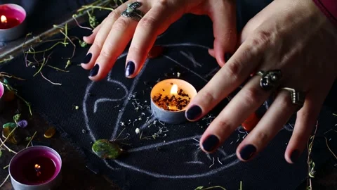 Witch hands performing a black magic ritual with the help of magical altar Stock Footage 252806184