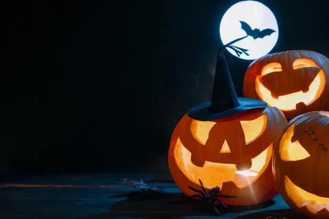 Witch Hat Jack-O'-Lanterns with Full Moon and Bat Background Stock Photos