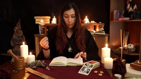 Witch hold over spell book and call spirits. Esoteric and divination concept. Stock Footage 108010342