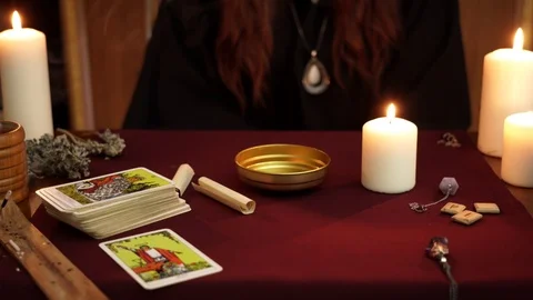 Witch hold spell in hands. Tarot cards, stones, white candles on dark background Stock Footage 108012888