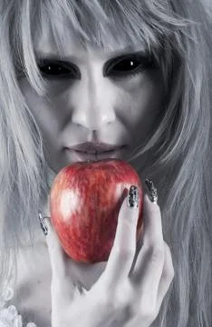 Witch holding an apple Stock Photos