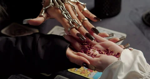 Witch holding client palm during mystical fortune ritual Video stock 320007435