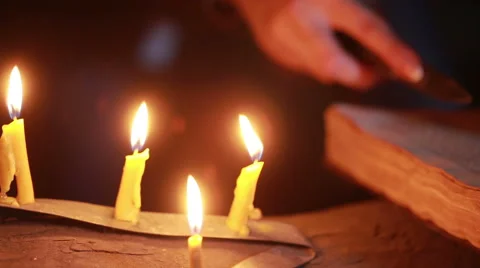 Witch holding the magic ritual. old book and candle. halloween Stock Footage 64668783