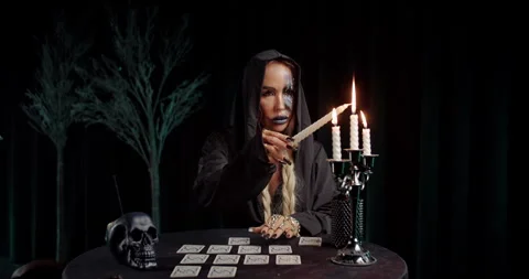 Witch holding ritual dagger over tarot spread Stock Footage 319602250
