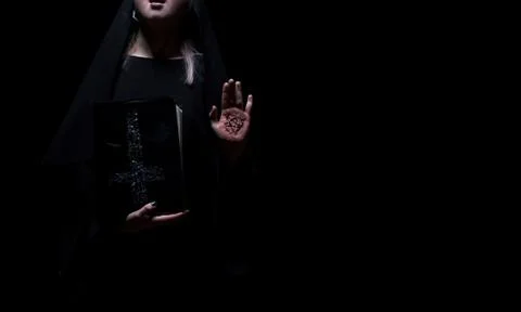 Witch holding a spell magic book with pentagram symbol standing. Halloween Stock Photos