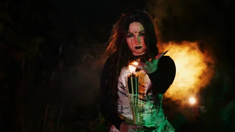 The witch holds a burning torch in her hands. Stock Footage 286087870