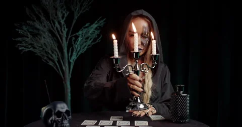 Witch illuminating tarot spread with candlelight Stock Footage 319600957