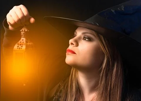 Witch with lighted lantern Stock Photos