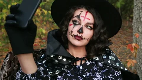The witch looks at the phone Stock Footage 141362710