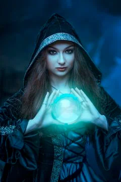 The witch with magic ball in her hands causes a spirits Stock Photos