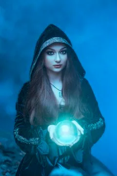 The witch with magic ball in her hands causes a spirits Stock Photos