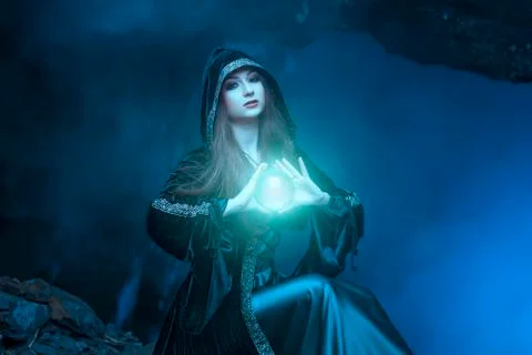 The witch with magic ball in her hands causes a spirits Stock Photos