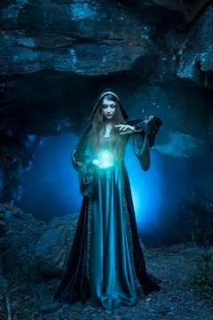 The witch with magic ball in her hands causes a spirits Stock Photos