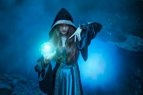 The witch with magic ball in her hands causes a spirits Stock Photos