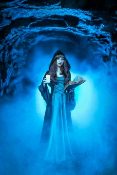 The witch with magic ball in her hands causes a spirits Stock Photos